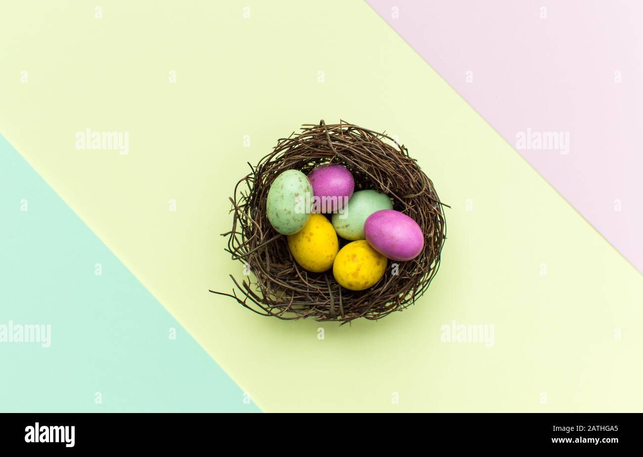Easter Eggs in a nest with a colourful background Stock Photo - Alamy