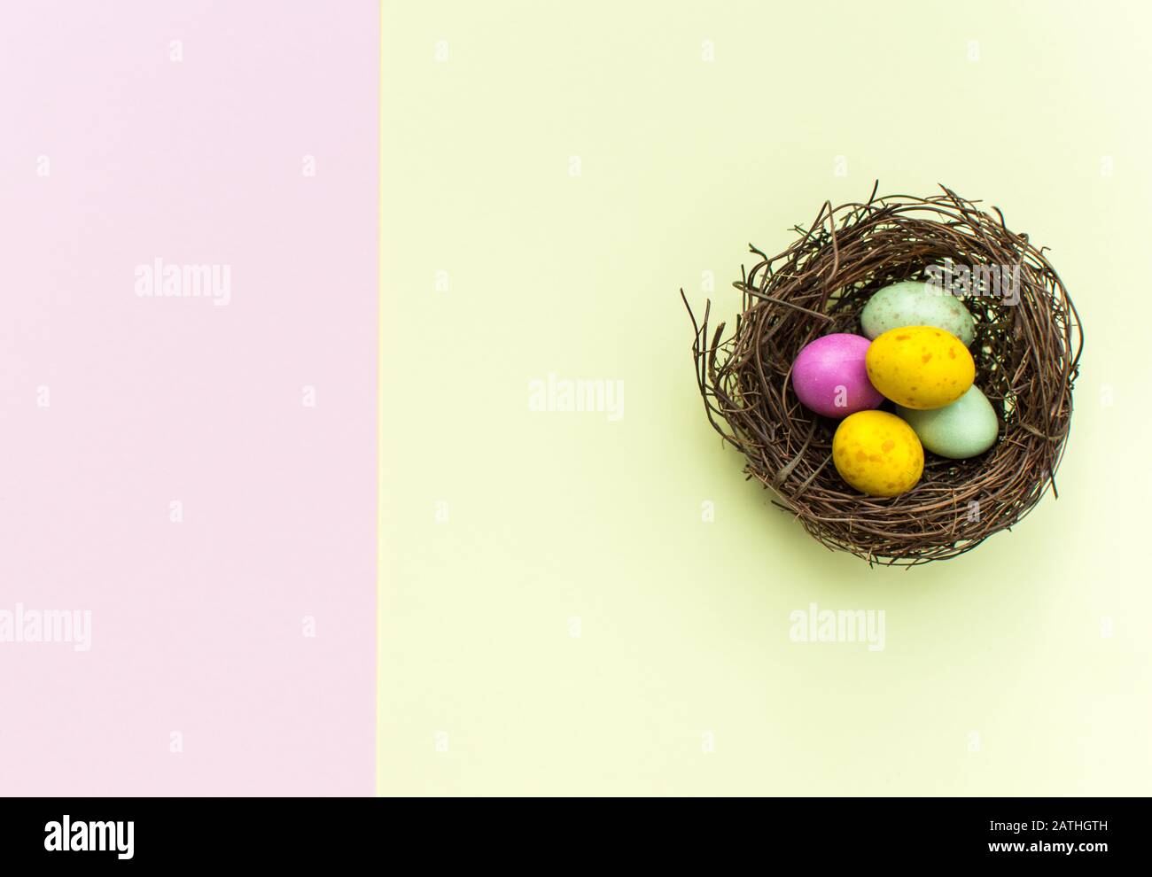 Easter Eggs in a nest with a colourful background Stock Photo