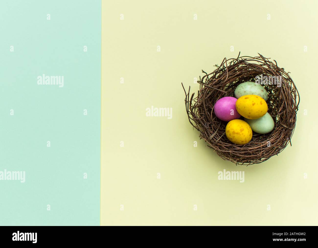Easter Eggs in a nest with a colourful background Stock Photo