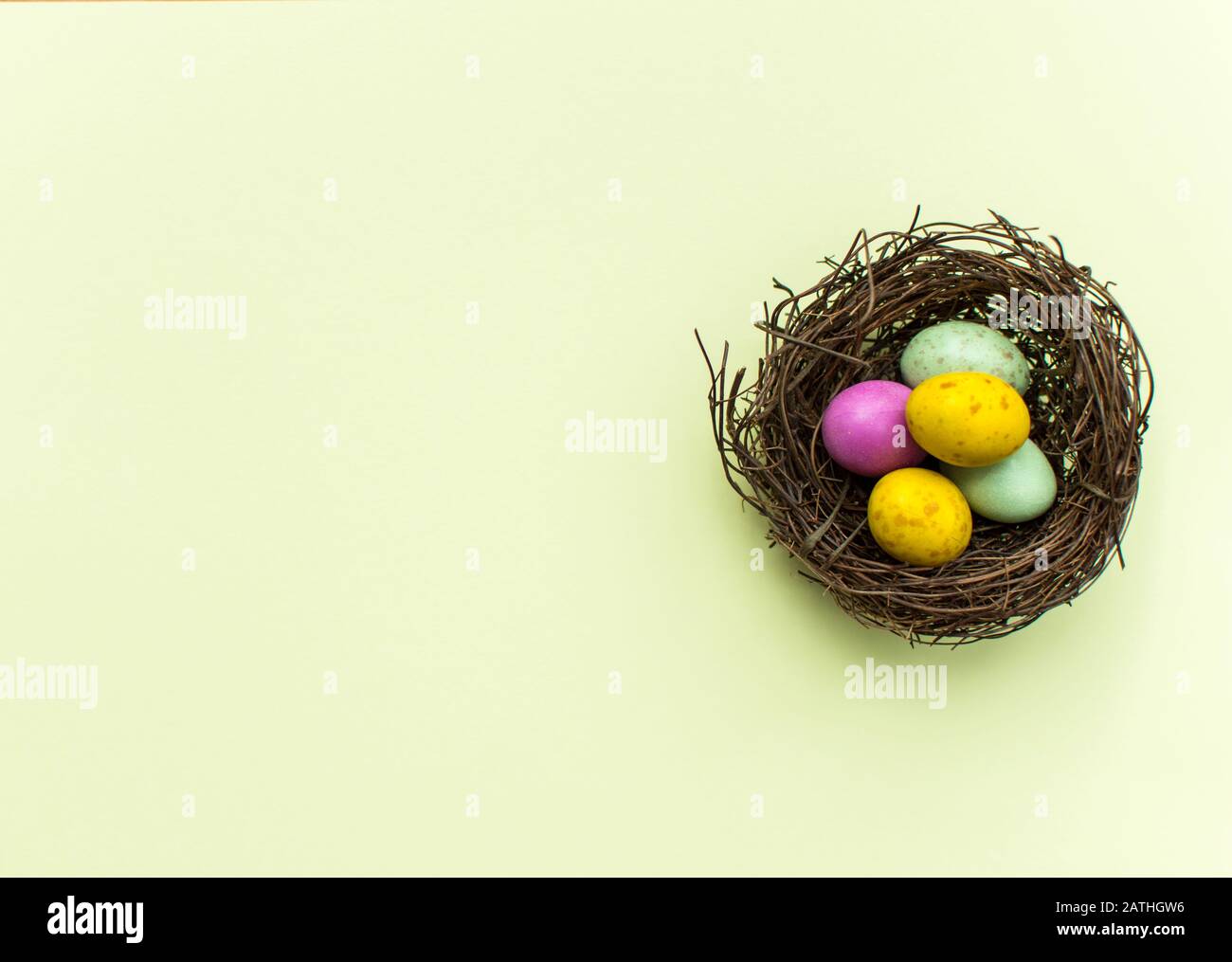 Easter Eggs in a nest with a colourful background Stock Photo