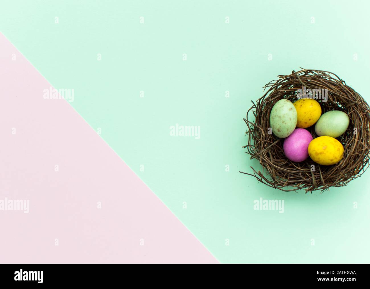 Easter Eggs in a nest with a colourful background Stock Photo - Alamy
