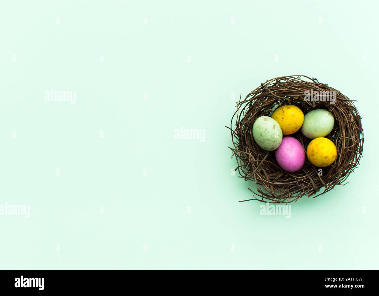 Easter Eggs in a nest with a colorful background Stock Photo