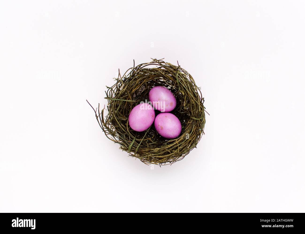 Pink Easter Eggs in a nest with a colourful background Stock Photo