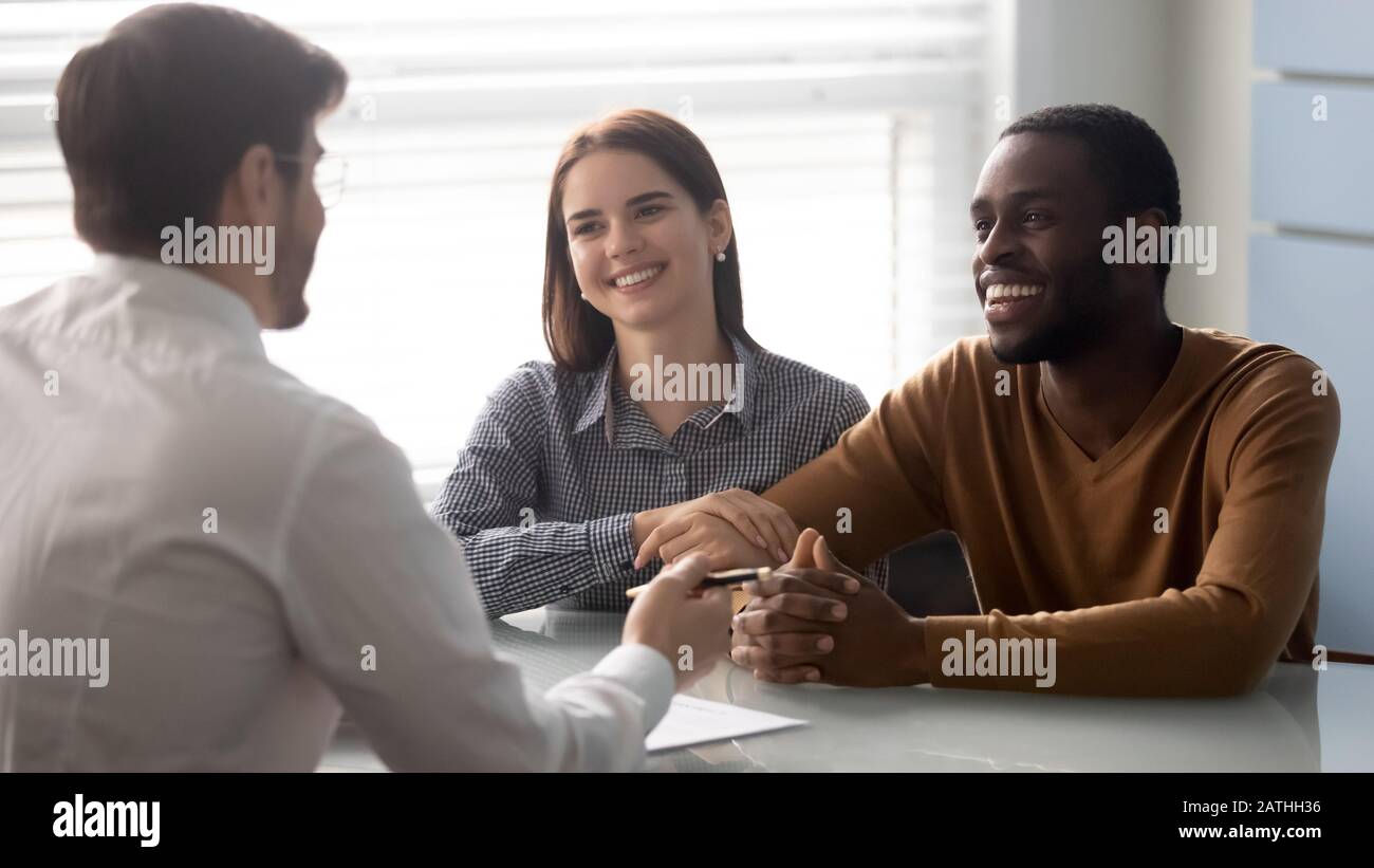 Interracial couple at meeting with financial advisor in office Stock Photo