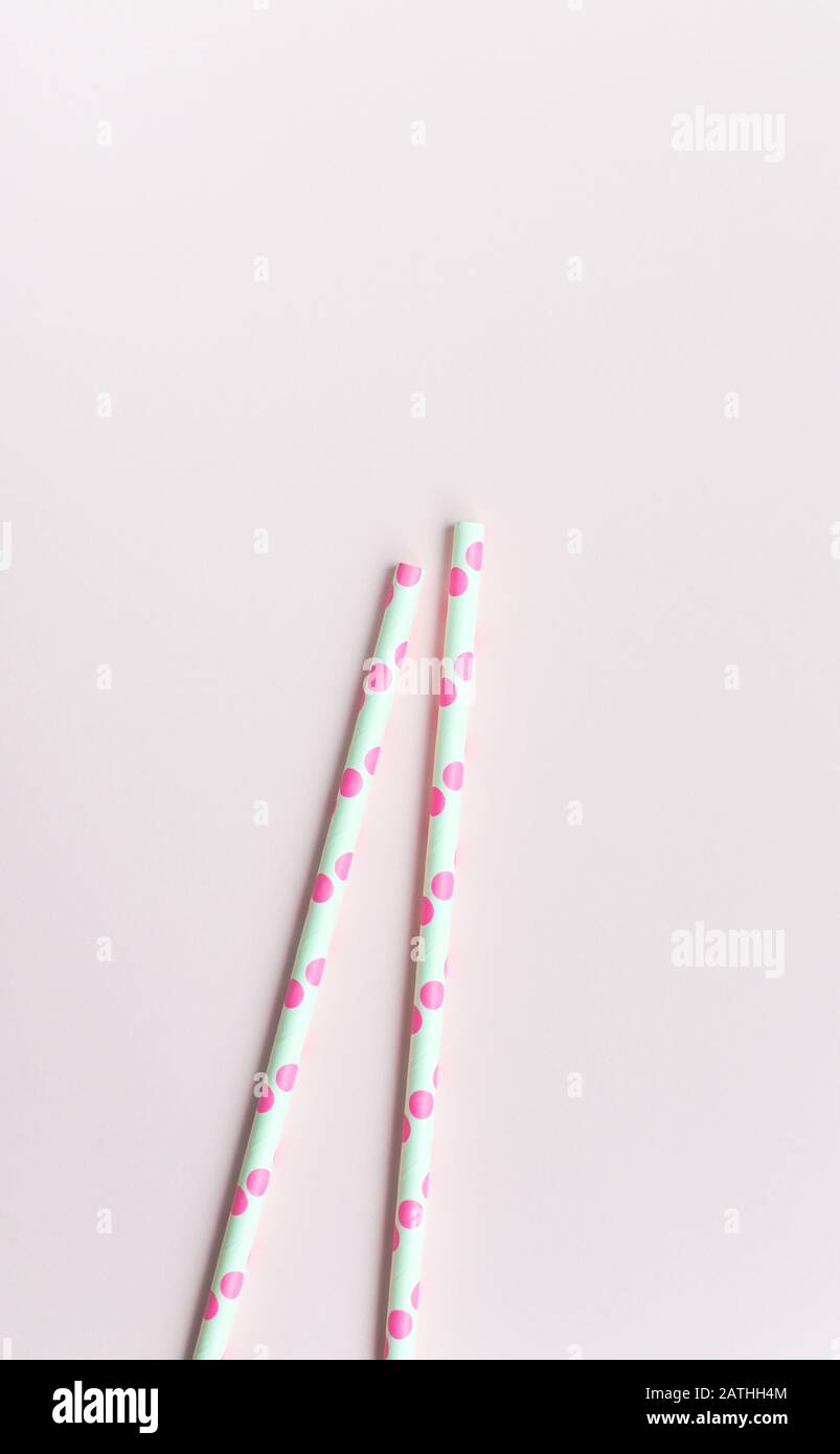 Pink straw on a pink background Stock Photo - Alamy
