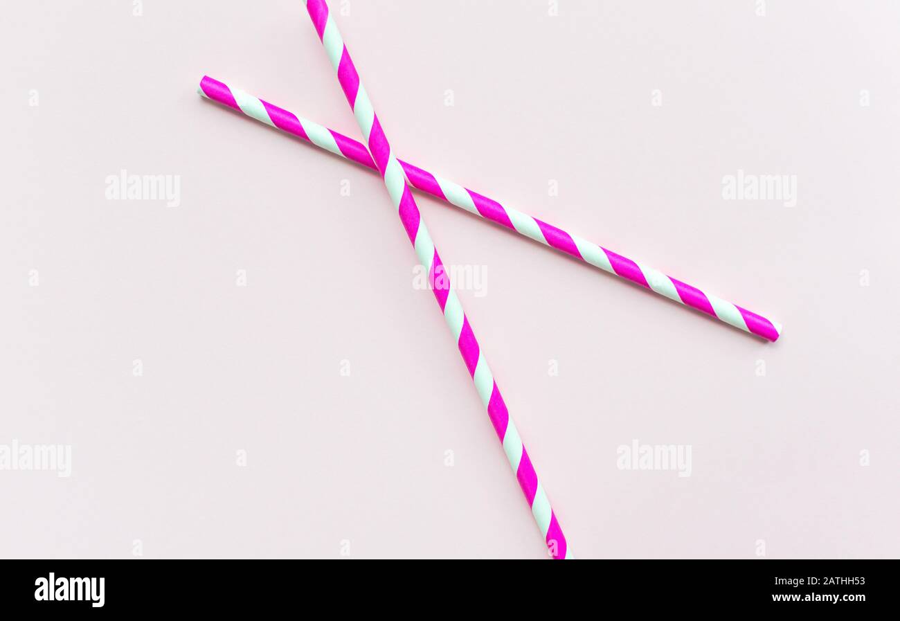 Pink straw on a pink background Stock Photo