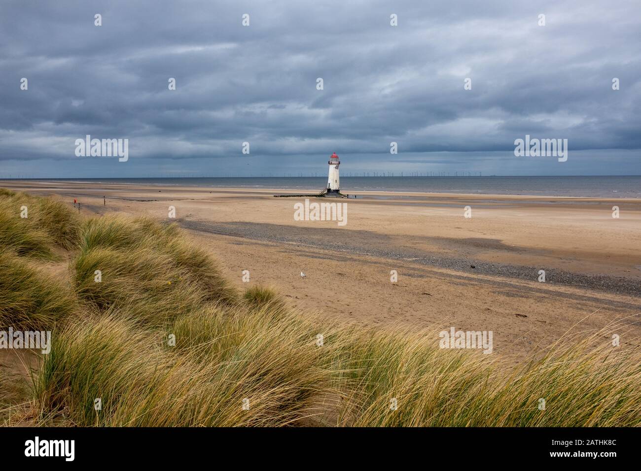 Talacre beach with the Talacre lighthouse (correctly called the Point of Ayr) under a cloudy sky Stock Photo