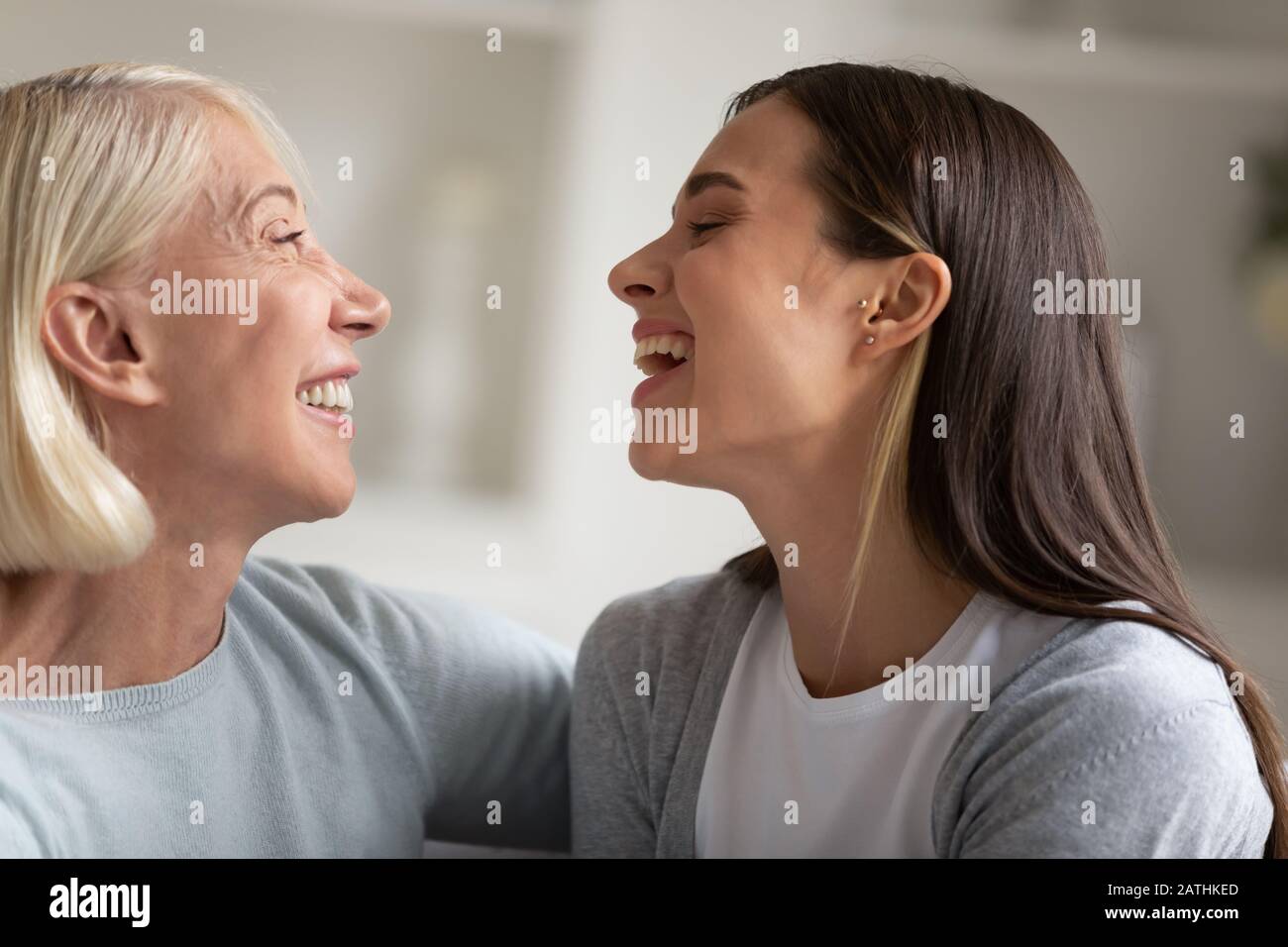 Overjoyed mature mom and adult daughter have fun at home Stock Photo