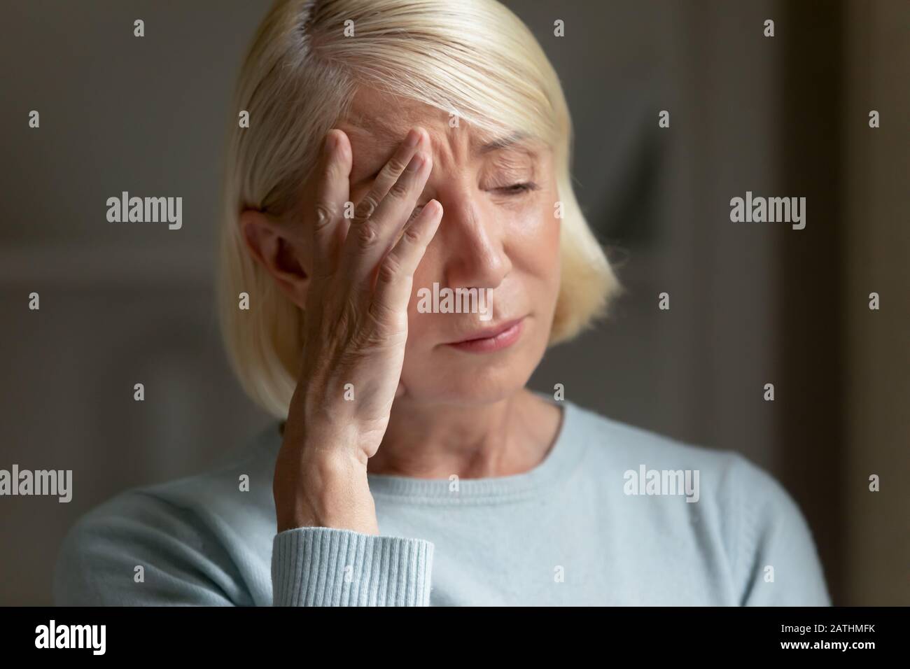 Upset mature woman feel lonely crying from despair Stock Photo