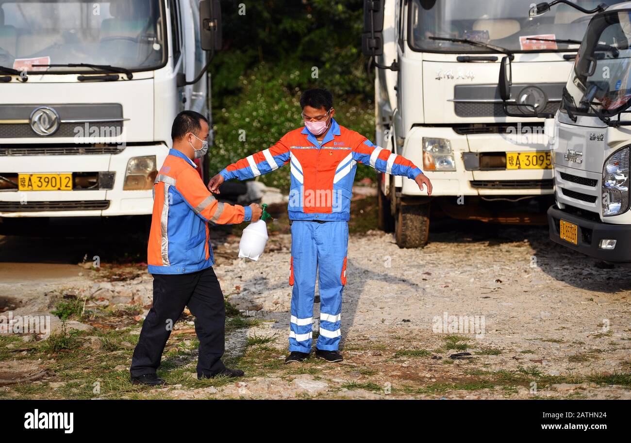 Haikou, China's Hainan Province. 3rd Feb, 2020. Chen Zhiyong receives disinfection after he takes off his protective suit in Haikou, south China's Hainan Province, Feb. 3, 2020. Chen is a sanitation worker in Haikou. After the outbreak of the novel coronavirus, he had taken the duty of transporting waste facial masks and garbages of a medical observation center. His work unit booked a hotel room for him and covered his meals. Amid the epidemic, Chen is the only customer of that hotel. Credit: Guo Cheng/Xinhua/Alamy Live News Stock Photo
