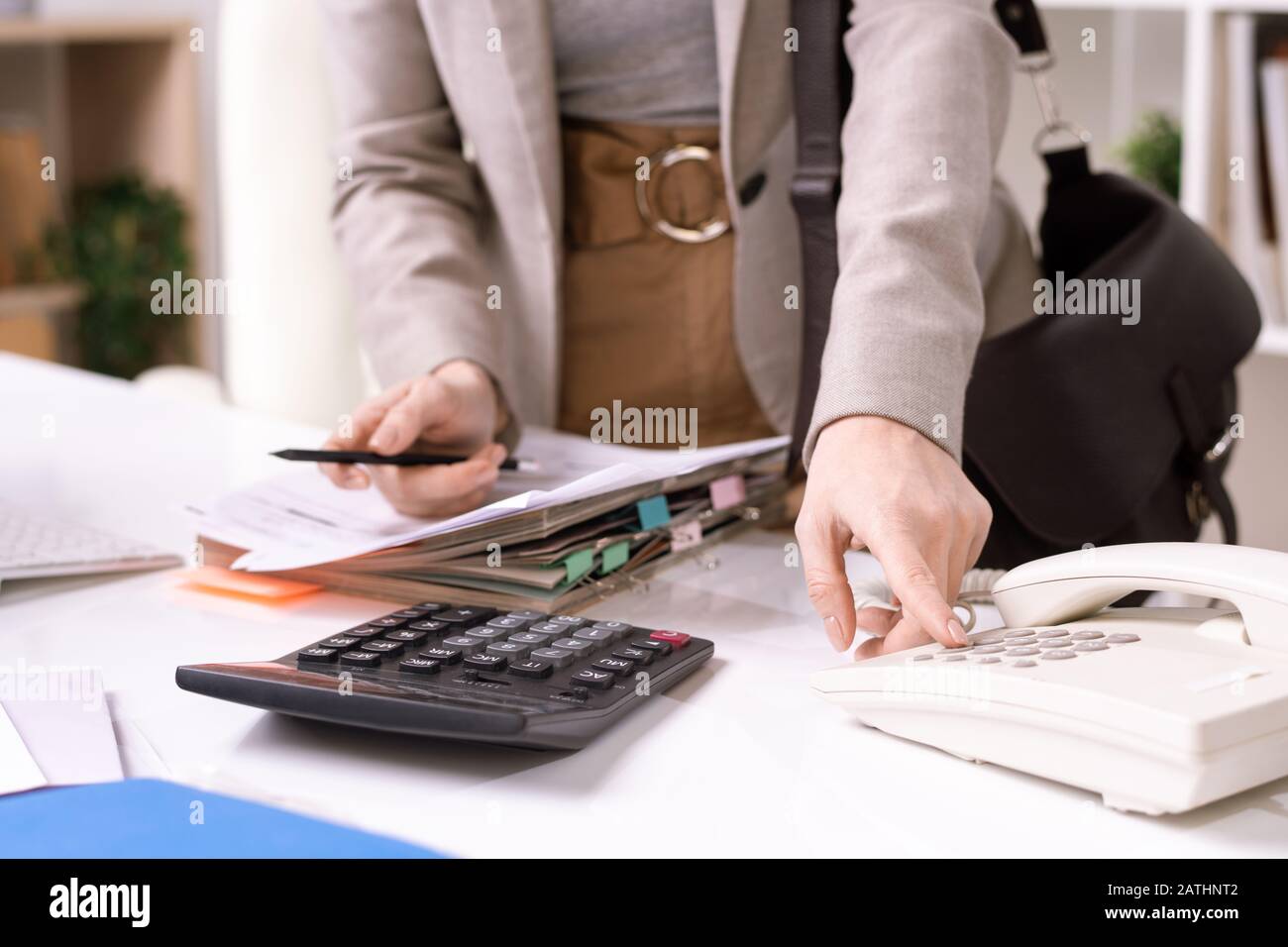 Close Up Of Unrecognizable Manager Standing At Desk With Papers