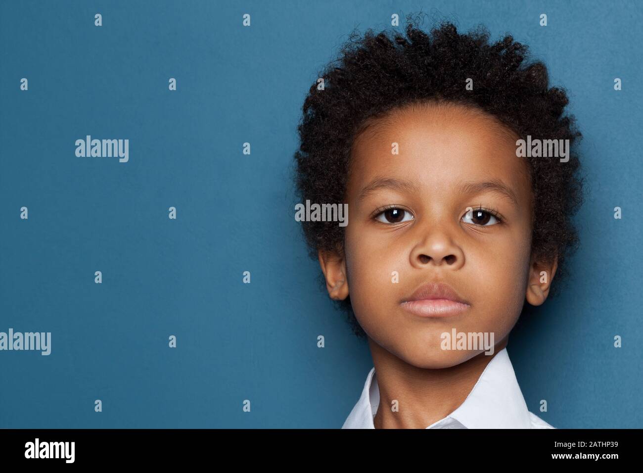Smart serious black kid boy face close up portrait Stock Photo
