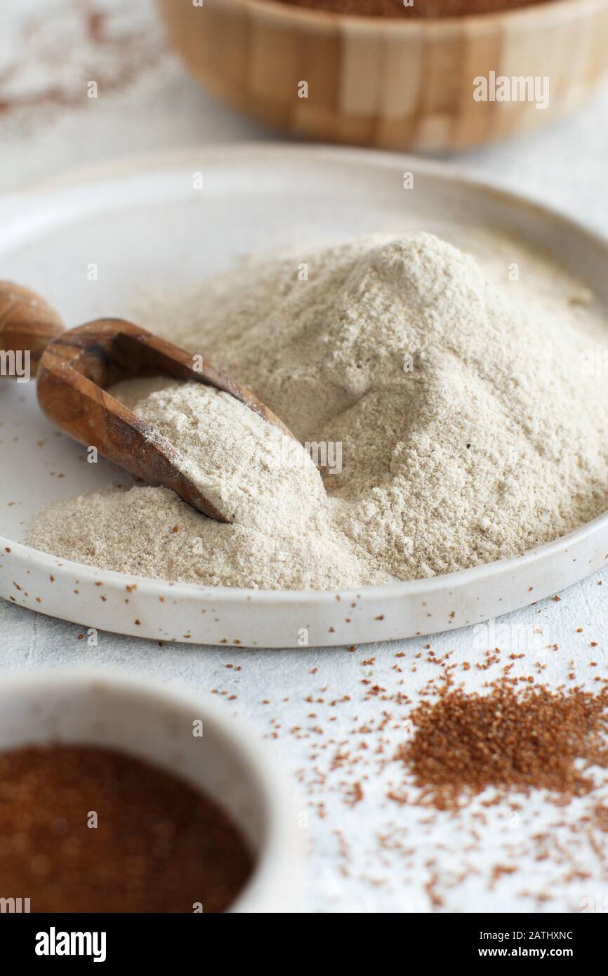 Teff flour in a plate with a spoon close up Stock Photo