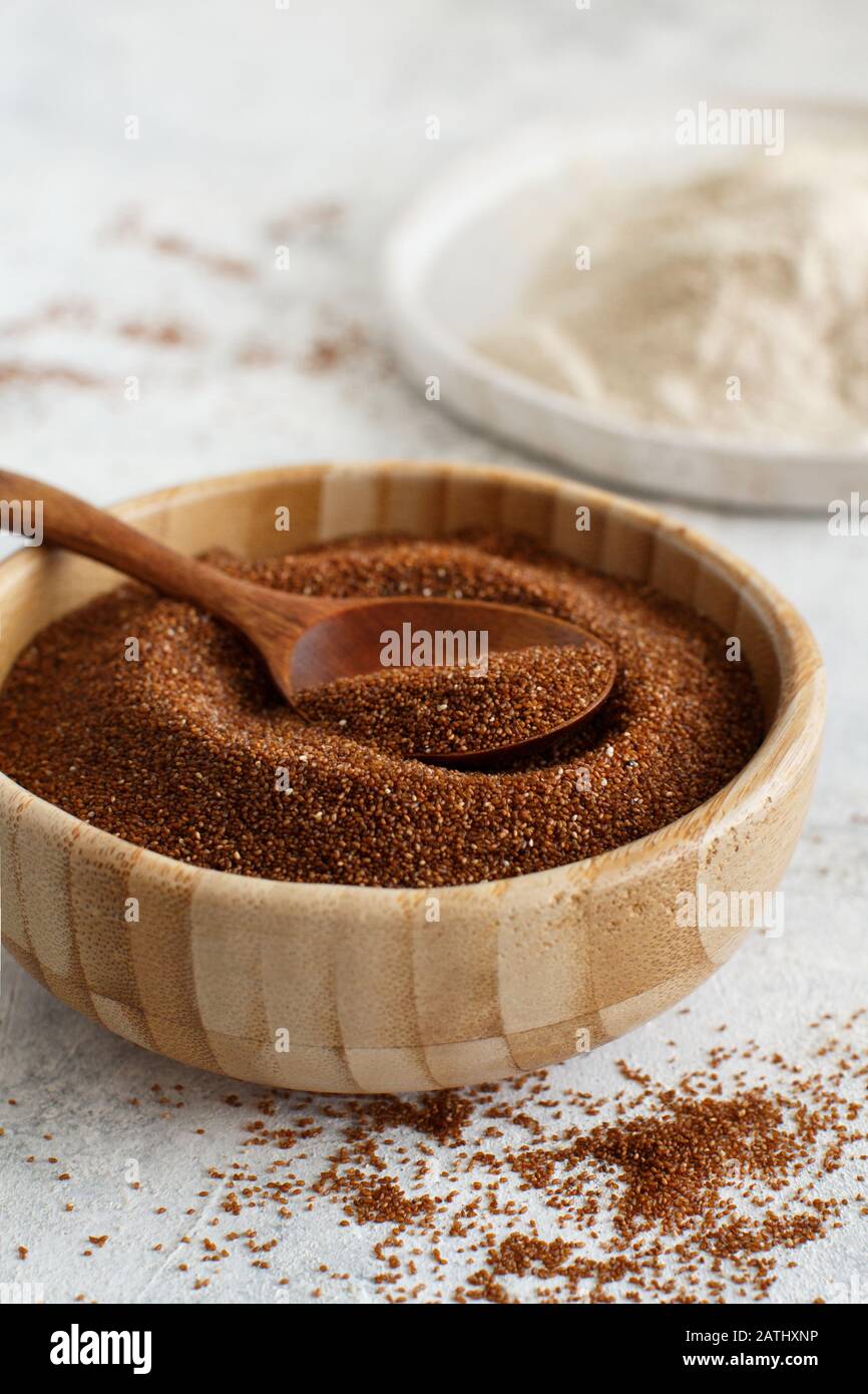 Raw teff grain in a bowl and teff flour close  up Stock Photo