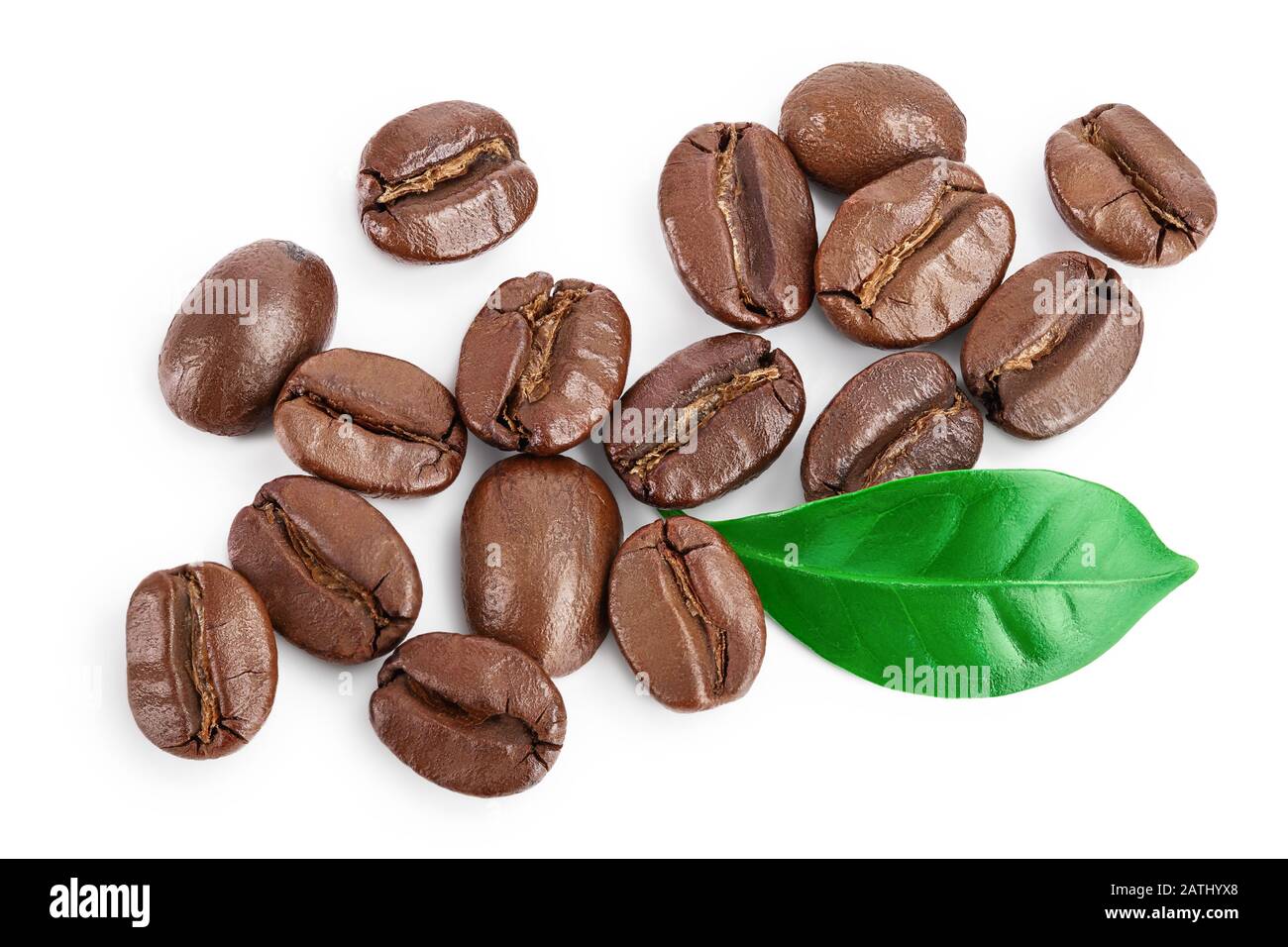 Heap of roasted coffee beans with leaves isolated on white background ...