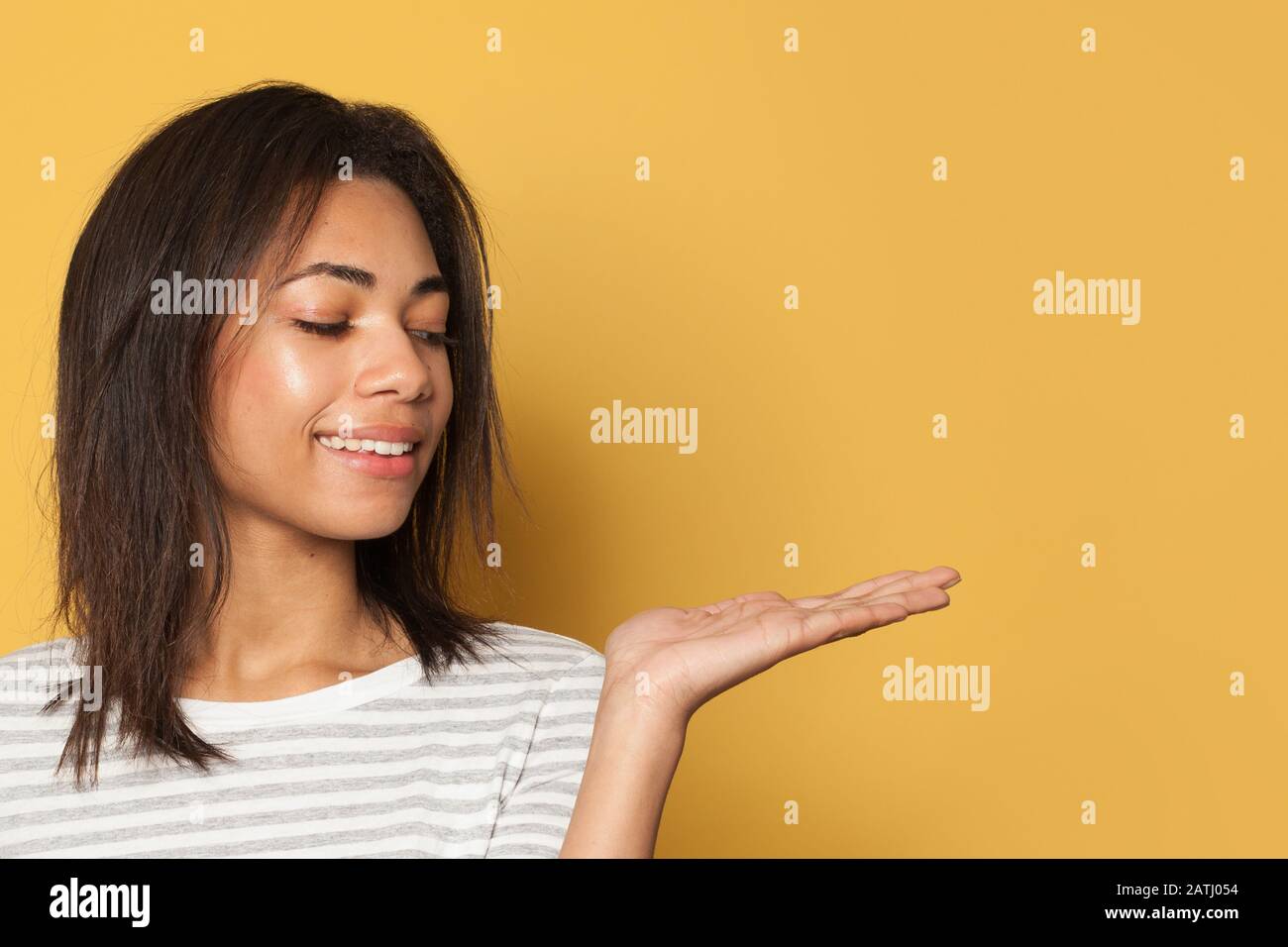 Happy Black Woman Showing Empty Open Hand For Advertising Marketing Or Product Placement On 