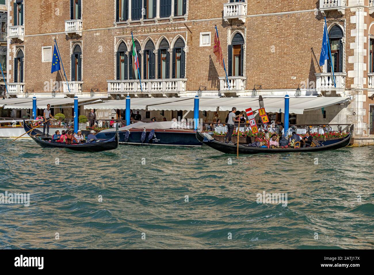 Tourists taking a gondola ride passing The Hotel Gritti Palace a luxury hotel on The Grand Canal ,Venice ,Italy Stock Photo