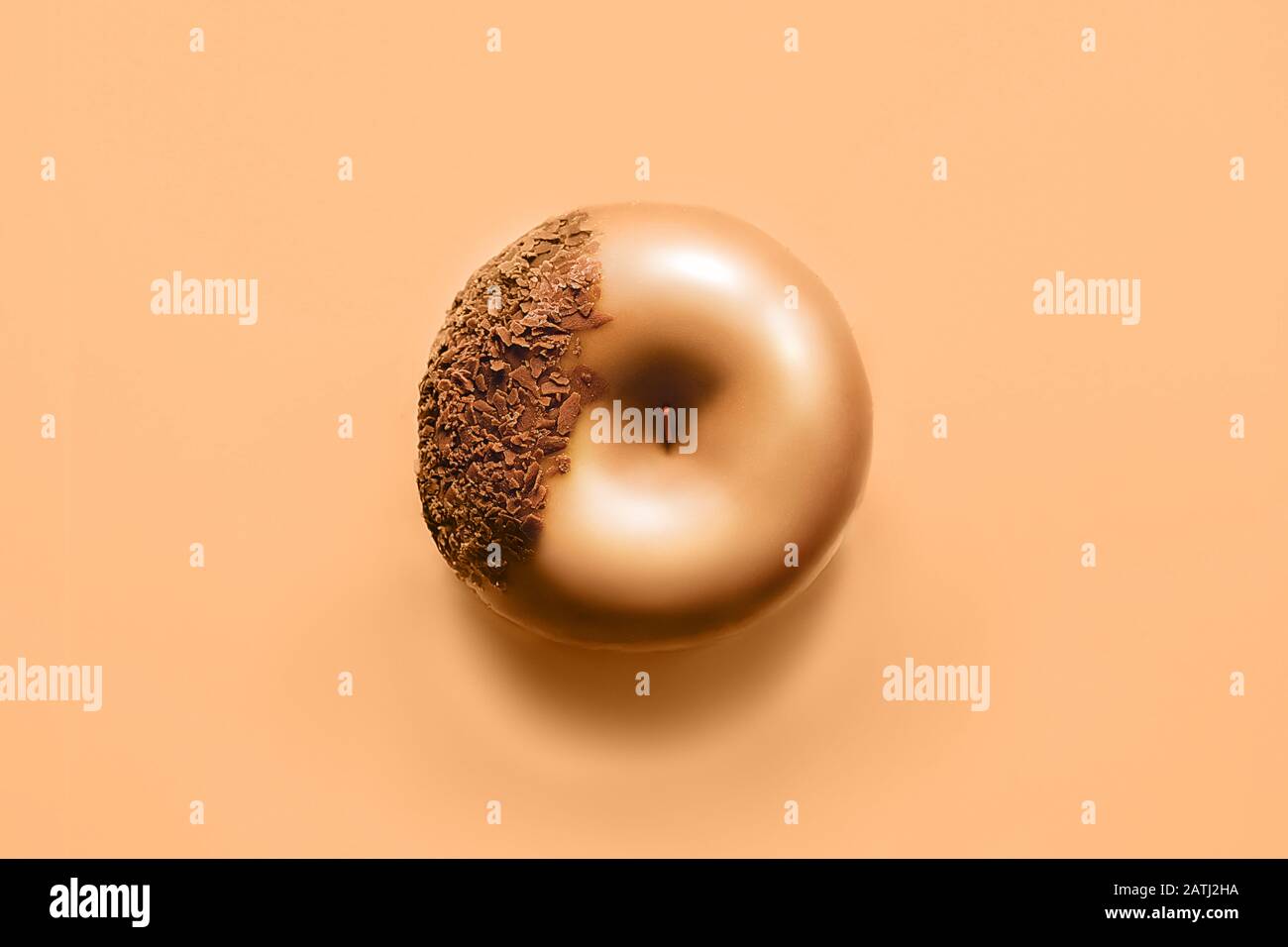 One donut with icing and chocolate on pastel light brown background ...
