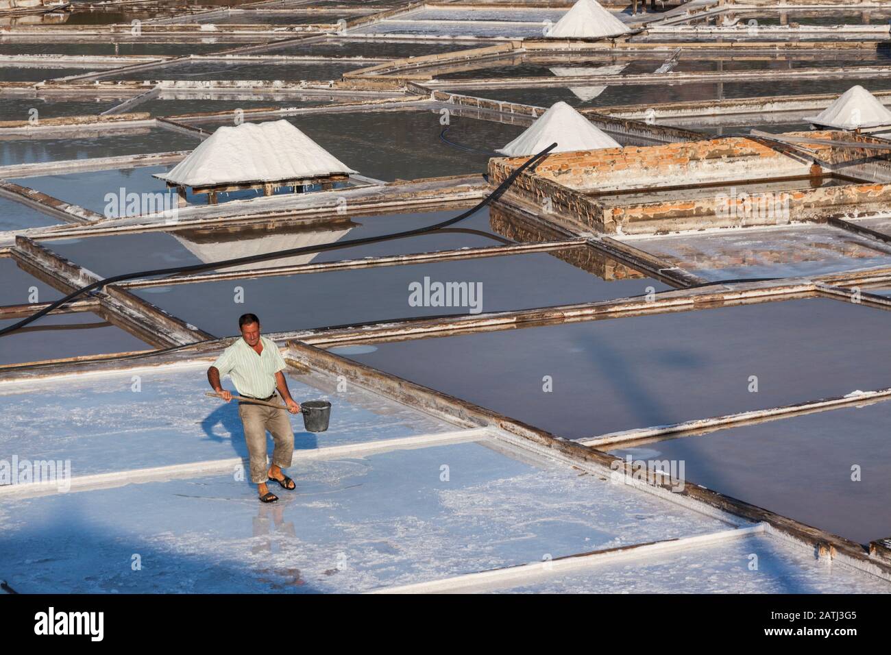 A co-operative worker managing his salt pan in Rio Maior, Portugal Stock Photo