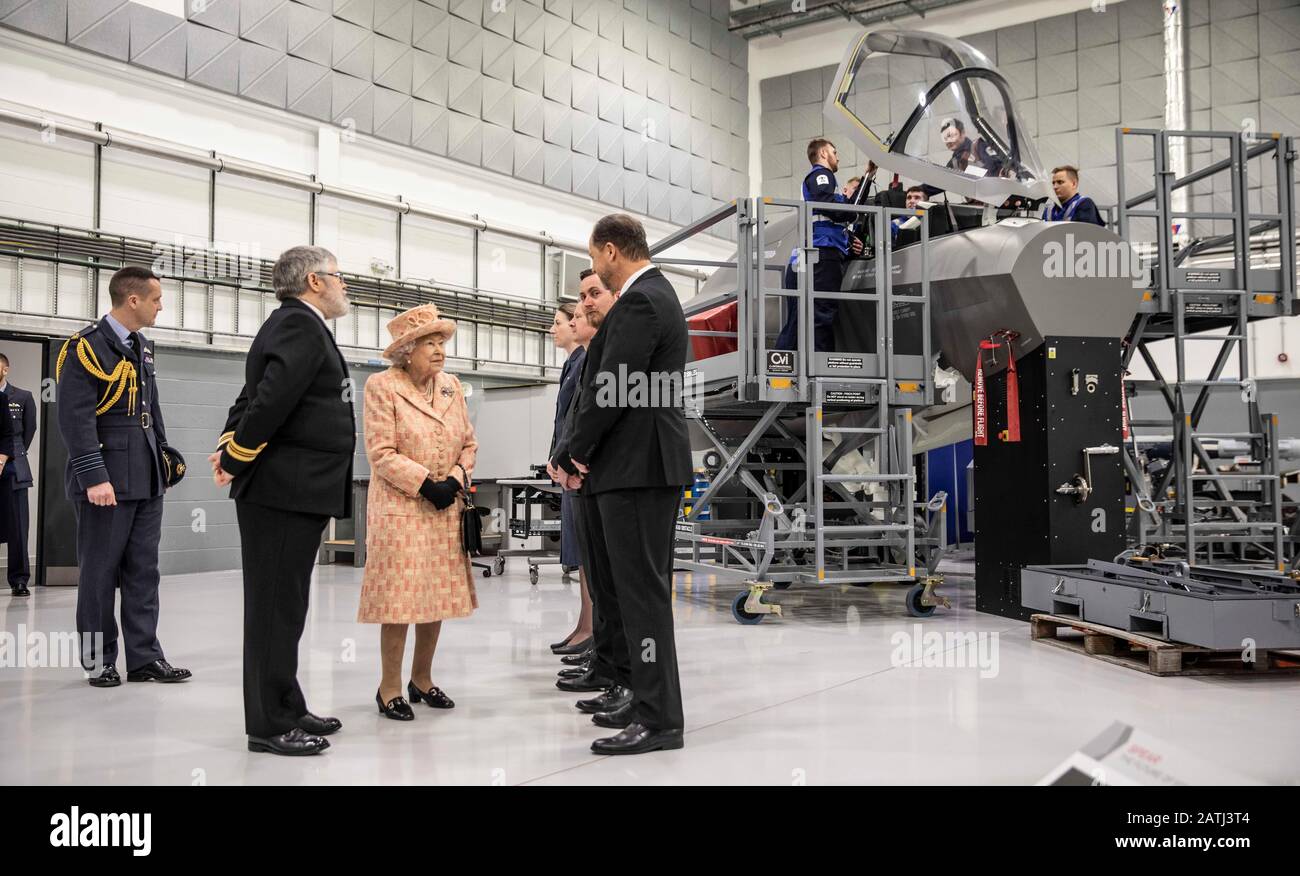 Queen Elizabeth II, with Station commander Group captain James Beck (left), is greeted by personnel during a visit to Royal Air Force Marham, Norfolk. Stock Photo
