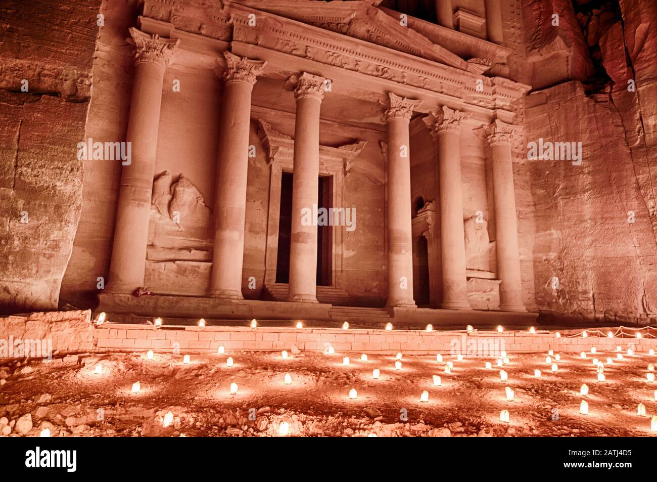 At night, the Treasury of Petra in Jordan is often illuminated by the light from hundreds of candles. Stock Photo