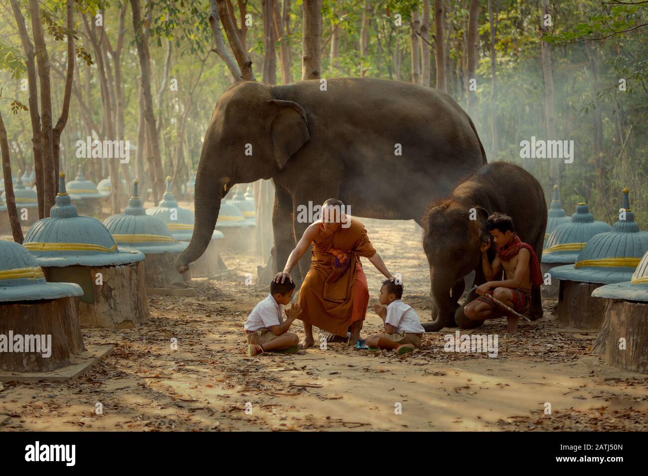 The monk and children enjoy in elephants park at Surin Thailand. Stock Photo