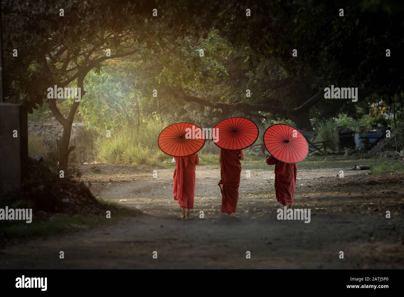 Three novice monks walking together go to the temple in Bagan Mandalay Myanmar. Stock Photo