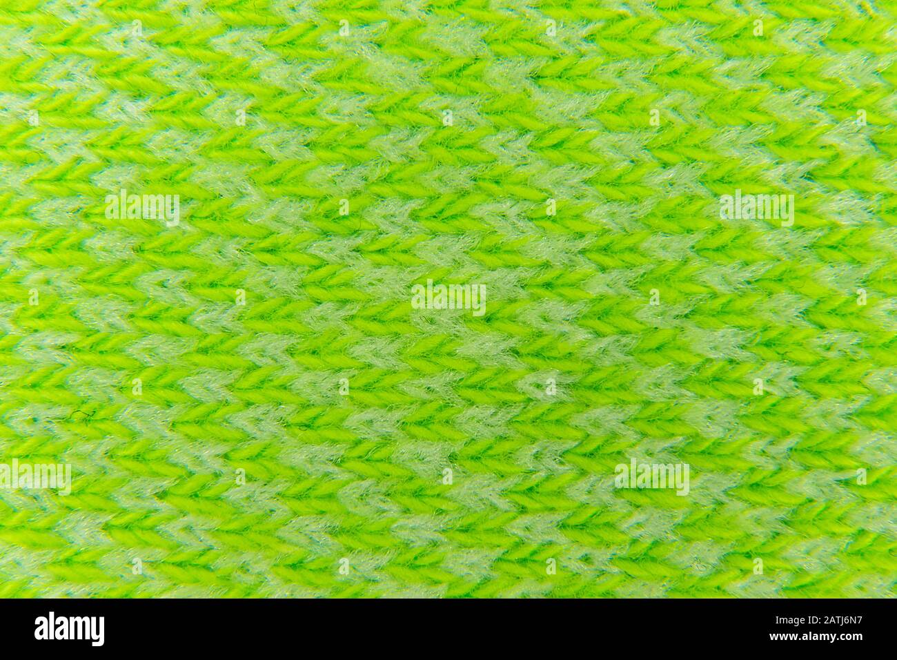image background from a canvas of green color knitted with woolen ...