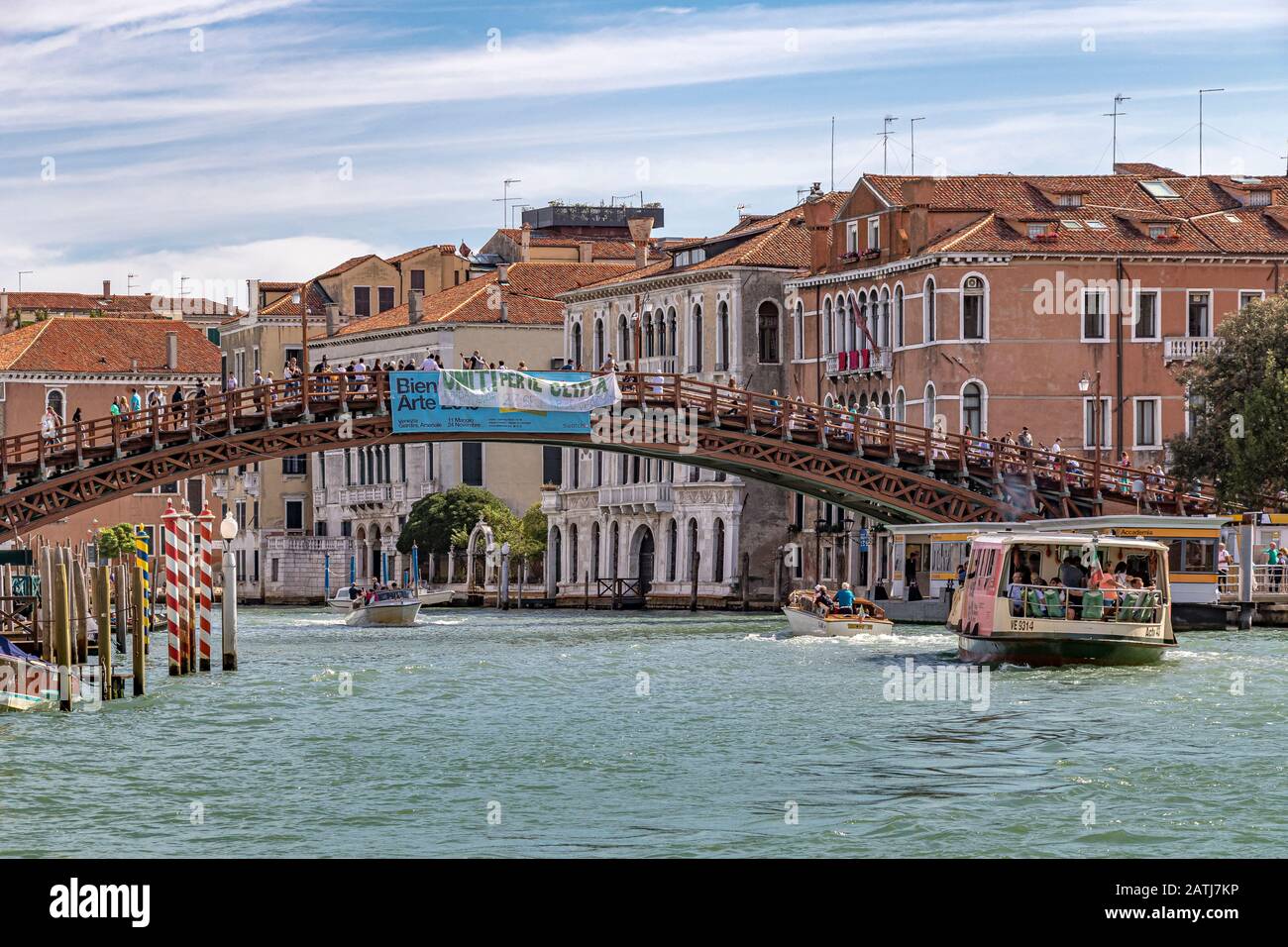 A Vaporetto or water bus approaching  The Ponte dell'Accademia ,one of only four bridges to span the Grand Canal ,Venice,Italy Stock Photo