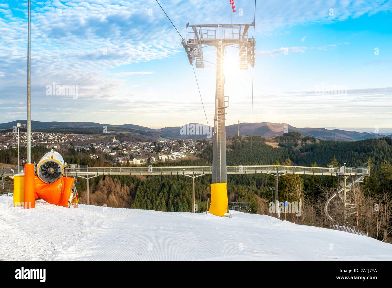 Ski lift and snow cannon in front of the panorama bridge. Adventure mountain 'Kappe 'in Winterberg. On the ski slope, panoramic views of forests and t Stock Photo