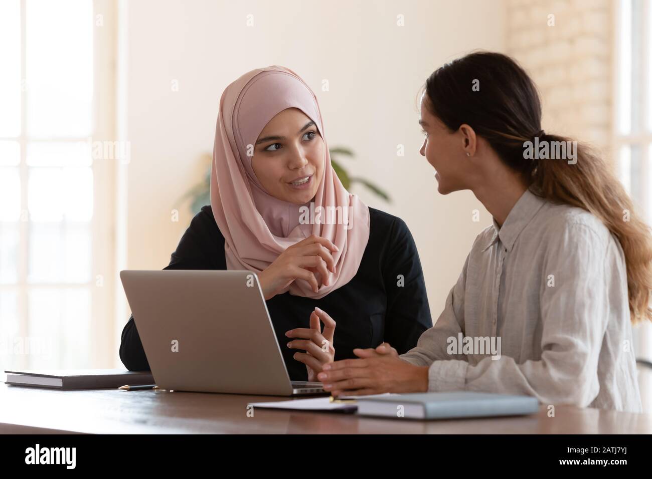 Multicultural businesswomen brainstorm cooperating at office meeting Stock Photo