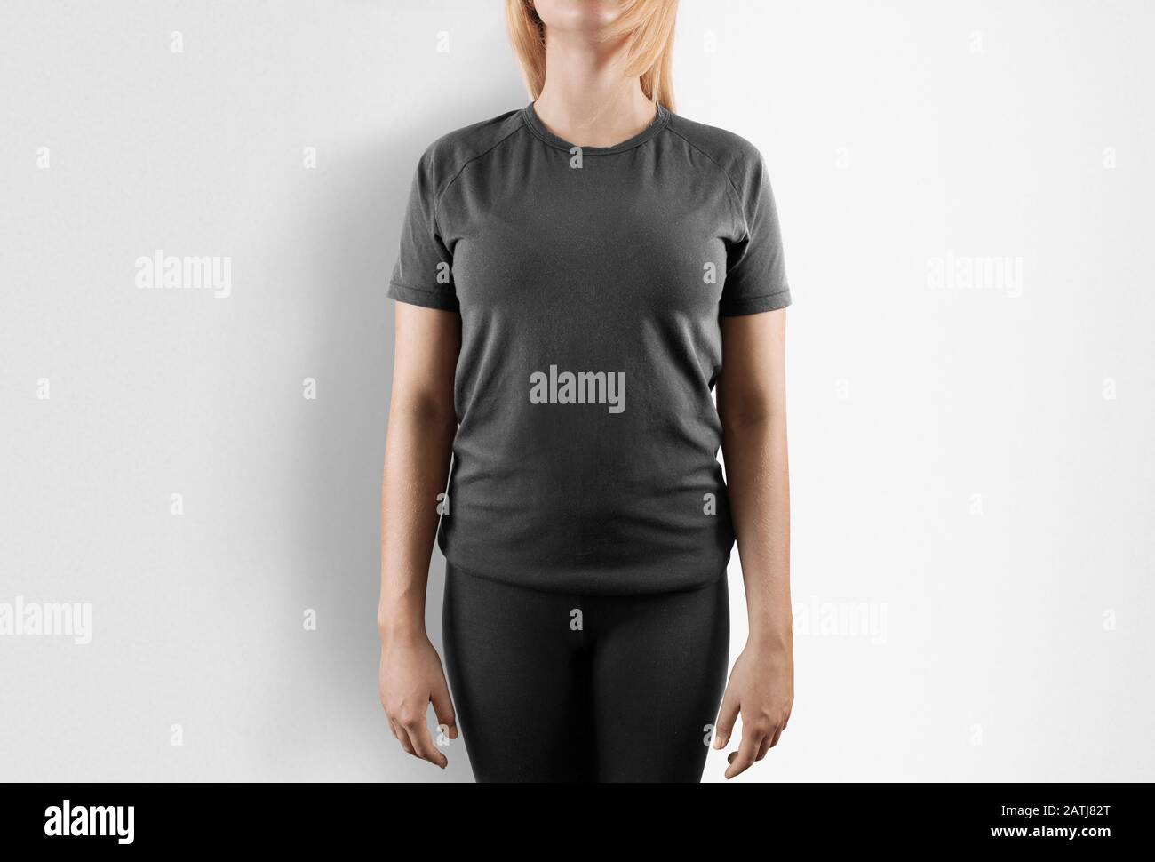 Blank grey t-shirt design mockup. Women stand in gray tshirt Stock Photo