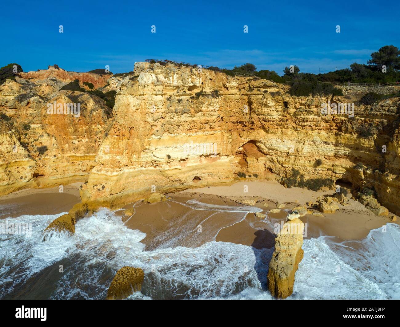 Rock cliffs and waves in Algarve Stock Photo