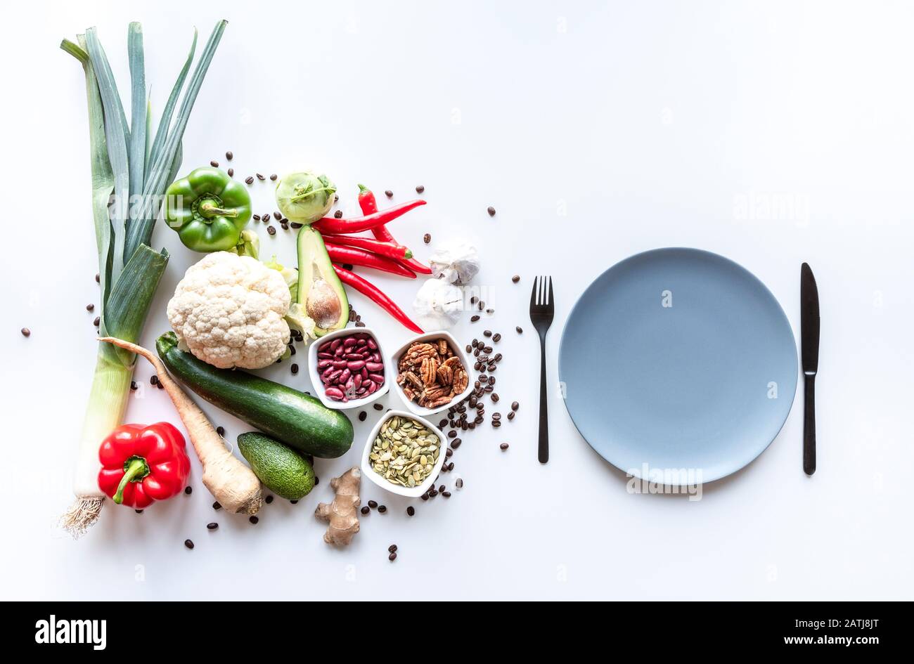 Top view of fresh group of vegetables on white background with plate ...