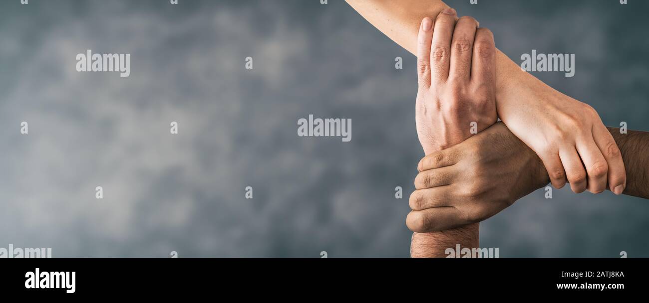 Top view of young people holding hands. Symbol and concept of unity, teamwork and support. Stock Photo