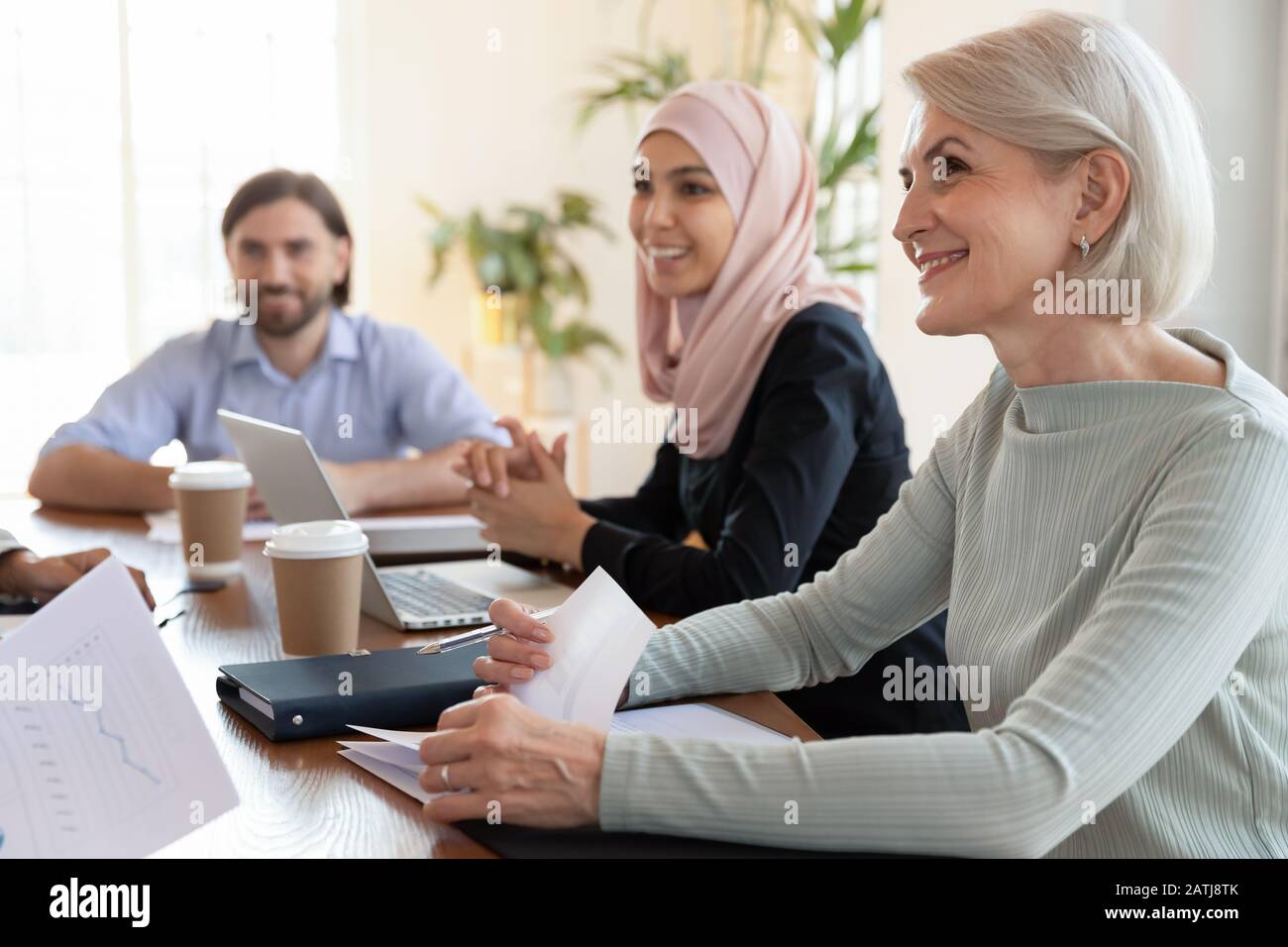 Smiling multiracial colleagues discuss ideas at office meeting Stock ...