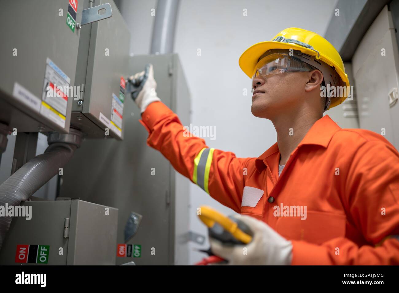 Electrician engineer checking electricity system in the box room energy building Stock Photo