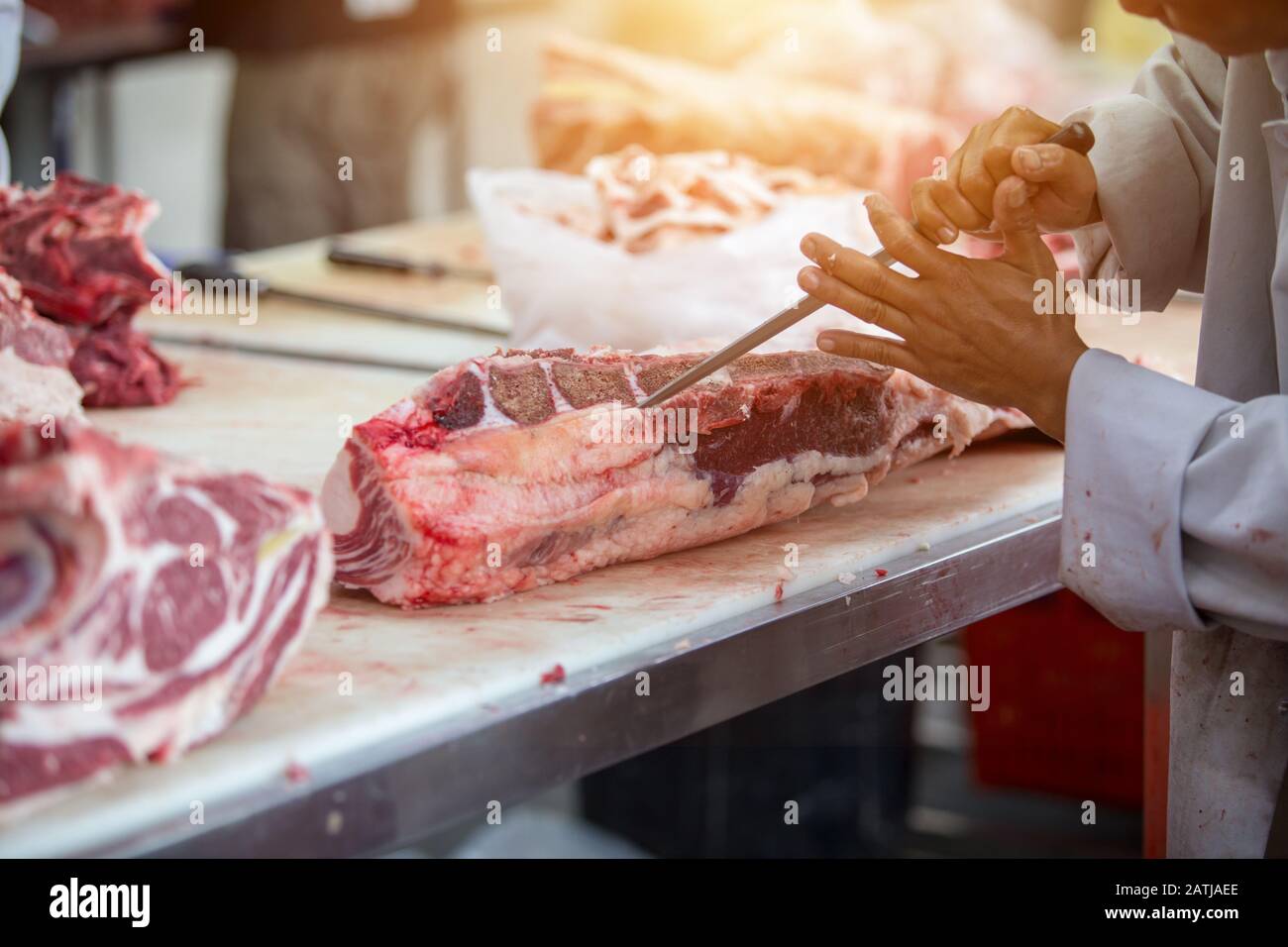 The men butcher working in the slaughterhouses or the butchery shop Stock Photo