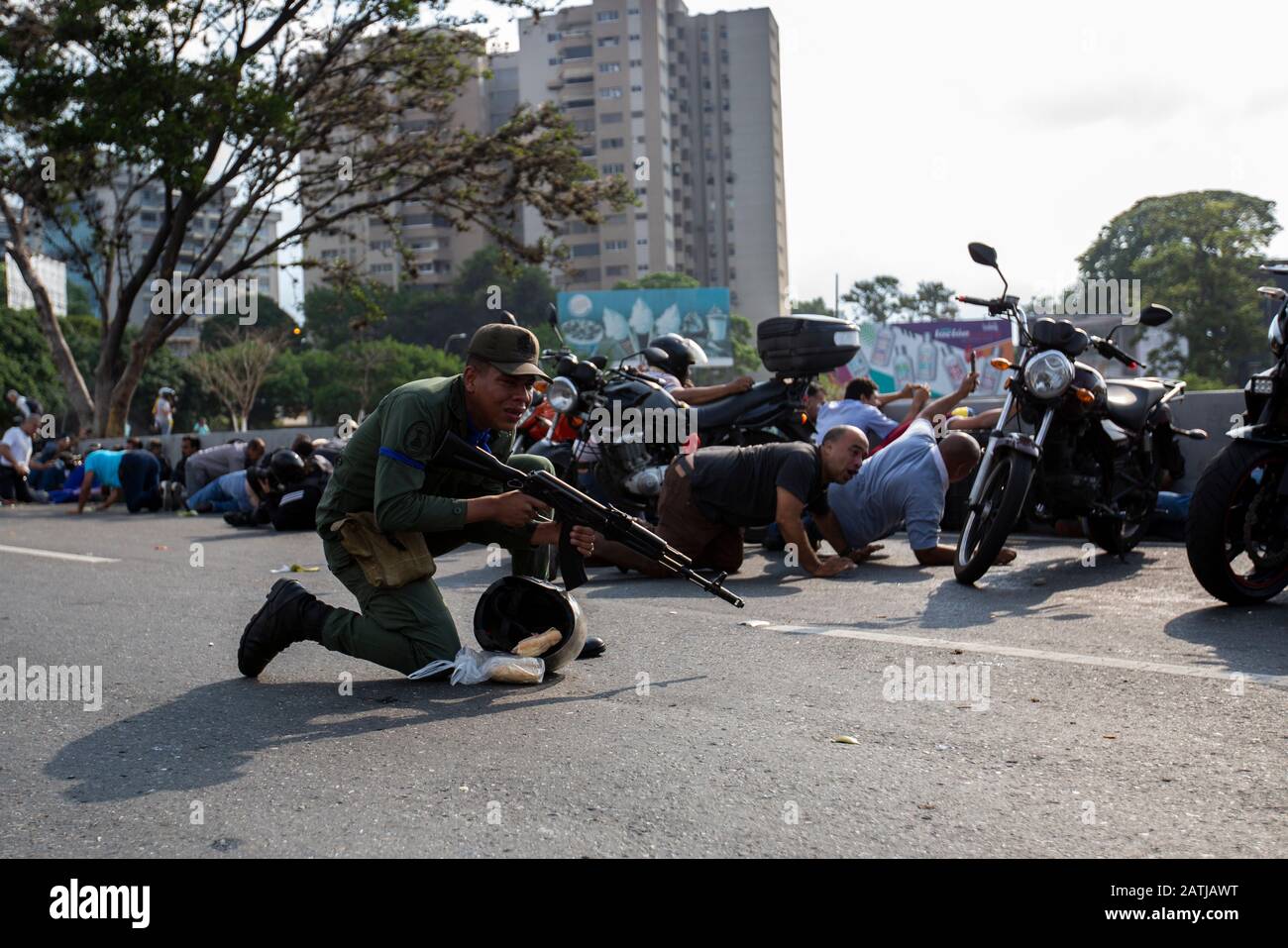 A rebel Venezuelan soldier is protected from alleged shooting that came from La Carlota air base. Caracas April 30, 2019 Stock Photo