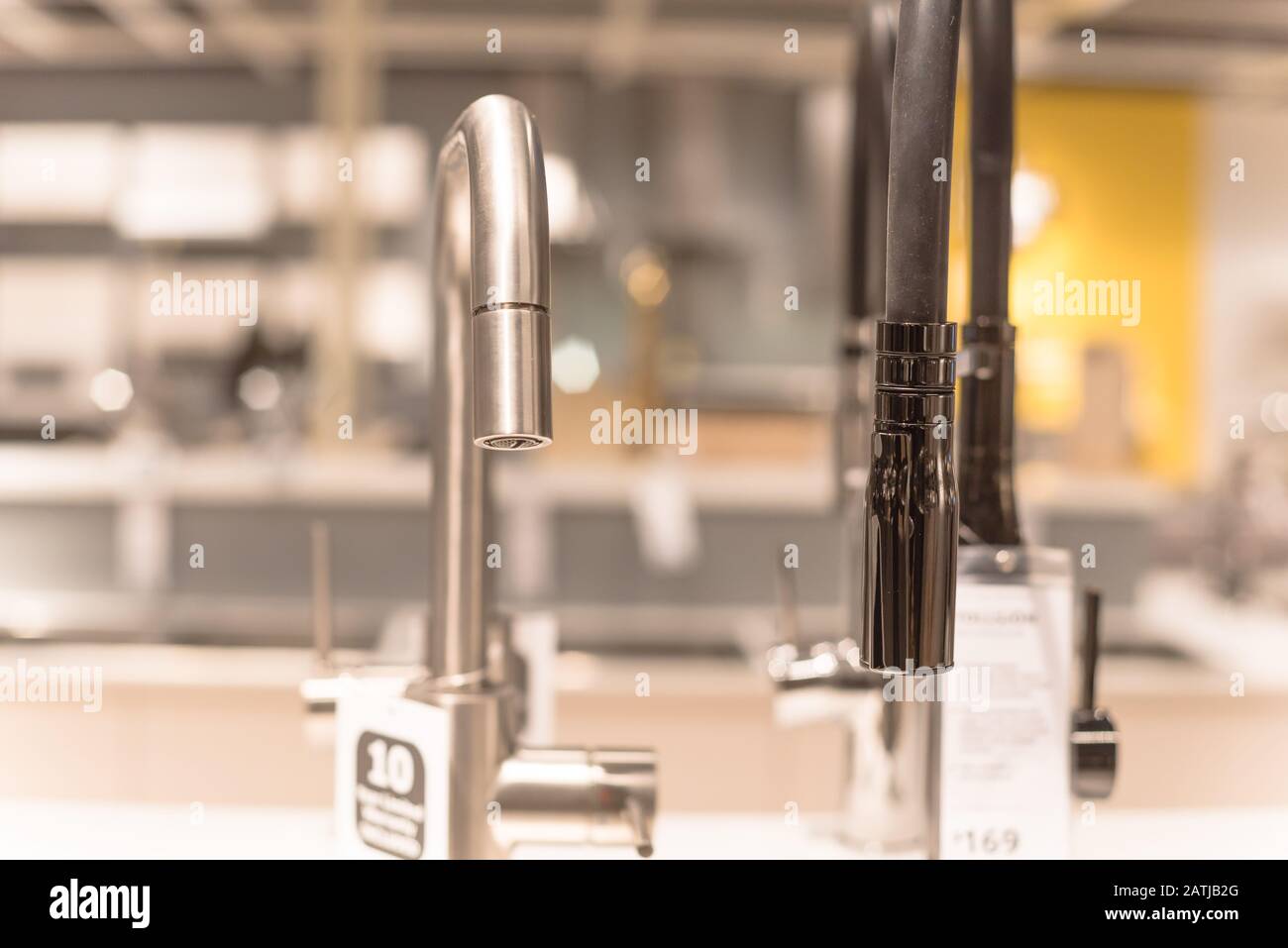 Shiny kitchen faucets with pullout sprout at furniture showroom in