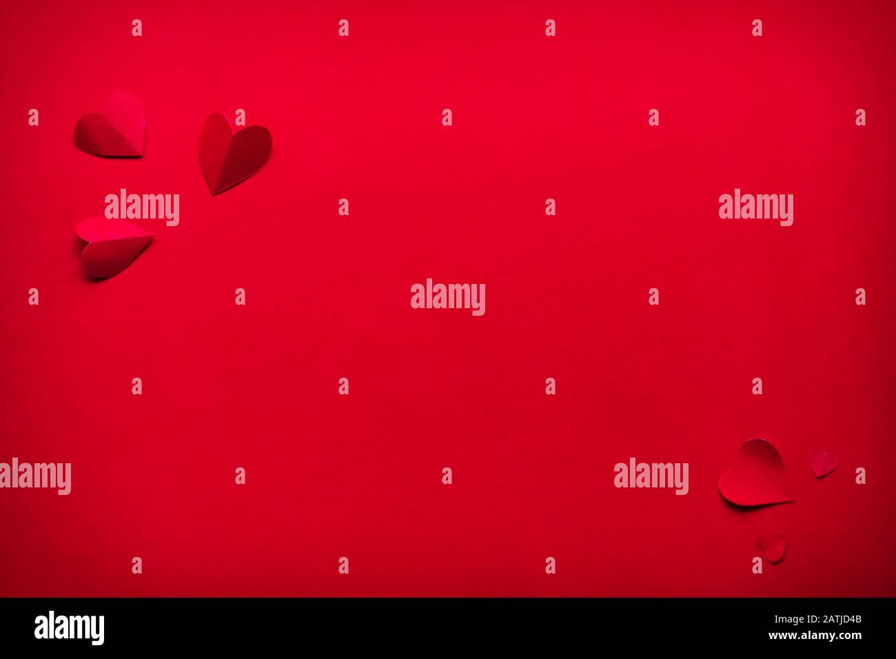 Valentine's Day background. Red hearts on a red background. Space for ...