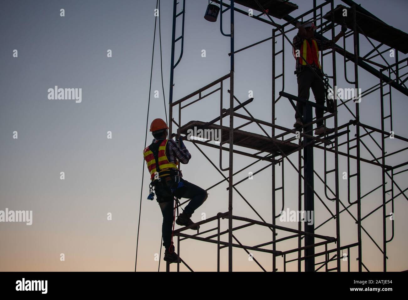 Engineer and worker are working on the high up of construction site Stock Photo