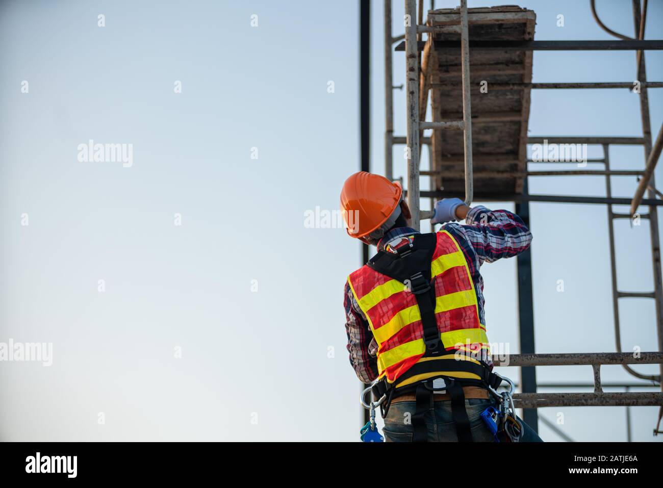 The worker on the construction site high up Stock Photo