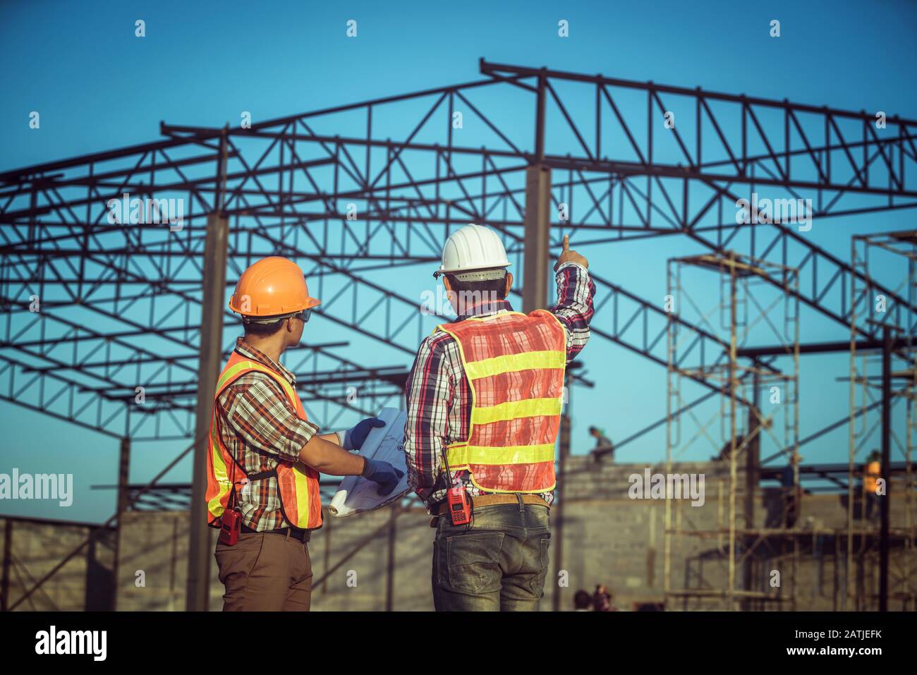 Engineering working in the construction and using the blueprint for checking construction Stock Photo