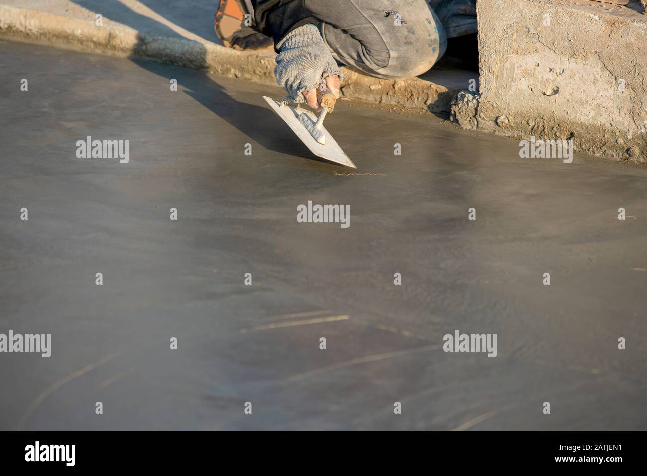 Plastering or pouring the floor with cement for construction Stock Photo