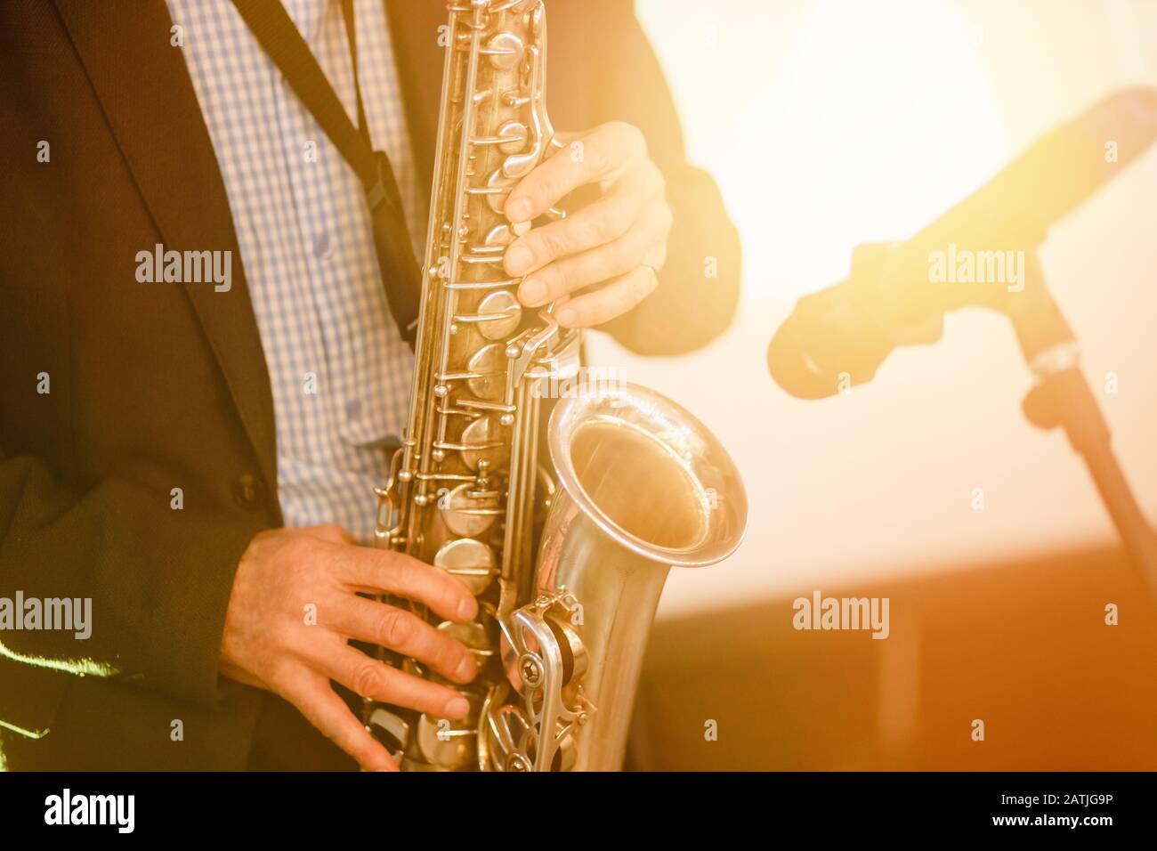 Jazz man musician playing saxophone with sun light Stock Photo