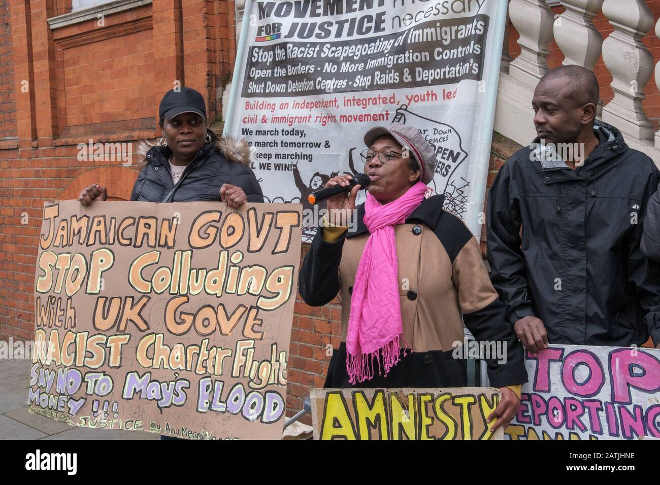 London, UK. 3rd February 2020. A black woman speaks at the Movement for Justice protest outside the Jamaican High Commission demanding Jamaica end accepting Britain's racist deportation flights. They say these are a modern equivalent of slave ships, with deportees manacled between guards for the flight. Those seized include many from Windrush families who have lived here most of their lives but are unable to produce the exhaustive paperwork demanded and seldom have the chance to properly contest their case. Peter Marshall/Alamy Live News Stock Photo