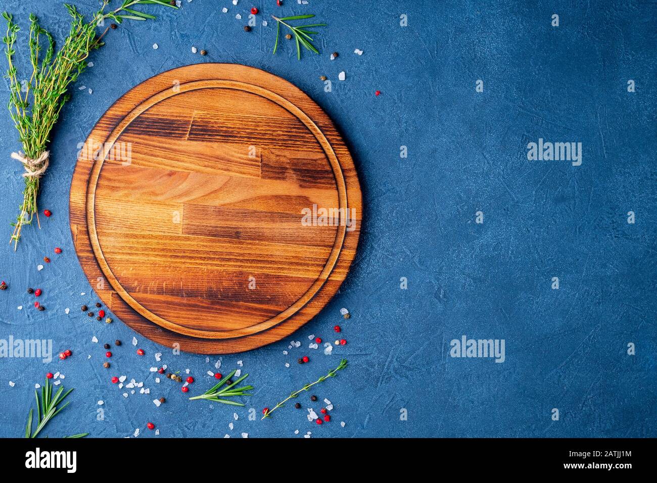 Spices, Herbs and round wooden cutting board on black blue dark concrete  backdrop. Top view, copy space. Menu, recipe, mock up, banner Stock Photo -  Alamy
