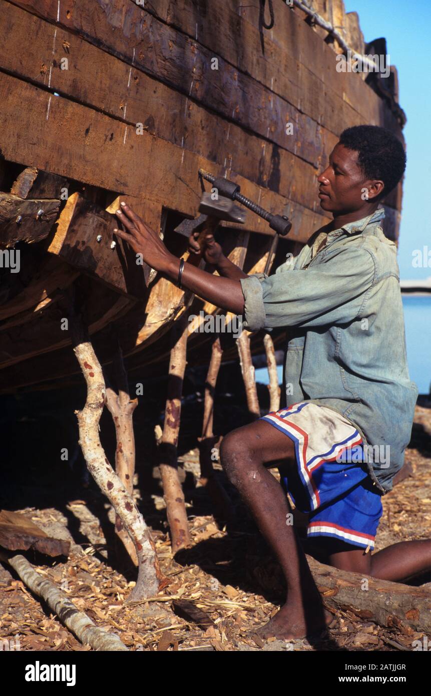 Malagasy Artisan or Boatbuilder Building a Traditional Wooden Dhow at Belo sur Mer near Morondavo western Madagascar Stock Photo