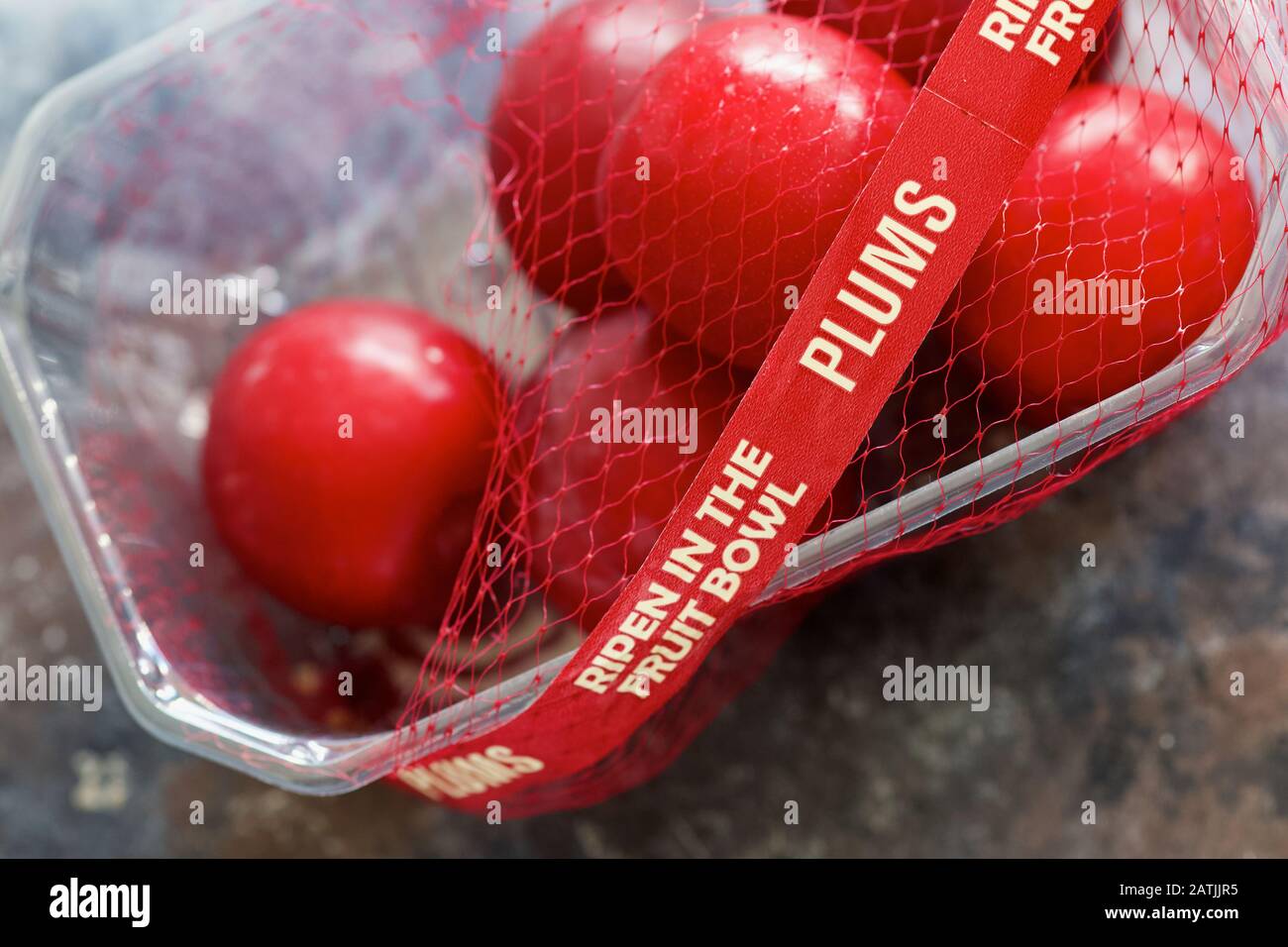 Red Plums Ripen in the Bowl Stock Photo
